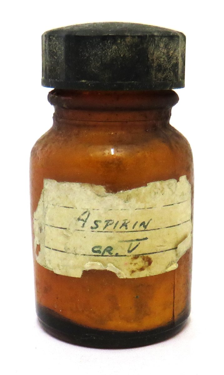 A brown glass bottle labelled "Aspirin" in handwriting, with a black cap.
