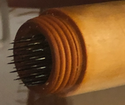 The pointed end of the lebenswecker, round with many tiny needles poking out.